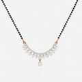 Necklace with black beads and a gold and diamond pendant on a white background