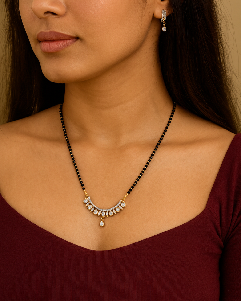 Close-up of a woman wearing a black beaded necklace with a silver pendant.